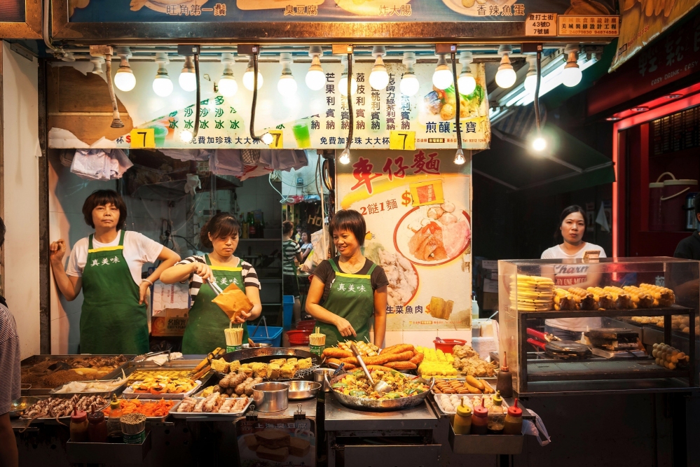 8  A Chinese takeaway food stall sells bubble egg waffles sui mei fried tofu octopus and other food items in Yau Ma Tei Kowloon Hong Kong Credit Alamy 2GYY479